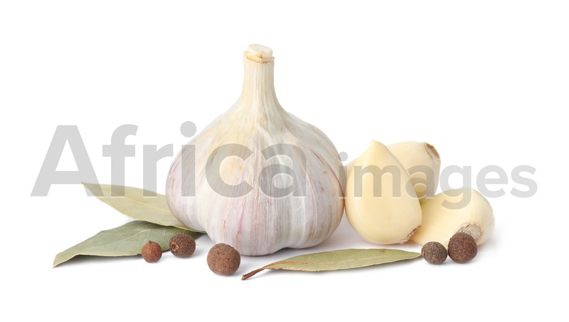 Fresh garlic bulb and cloves with seasonings isolated on white. Organic food