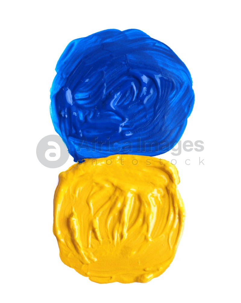 Photo of Yellow and blue paint circles drawn with brush on white background, top view