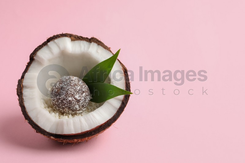 Delicious vegan candy ball in coconut on pink background. Space for text