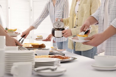 People taking food and pouring coffee during breakfast, closeup. Buffet service