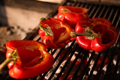 Cooking delicious fresh bell peppers on grilling grate in oven, closeup