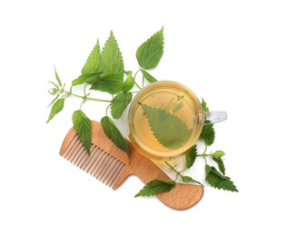 Stinging nettle infusion, green leaves and comb on white background, top view. Natural hair care