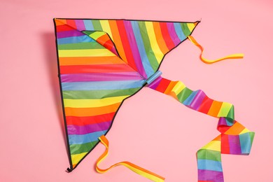 Beautiful bright rainbow kite on pink background