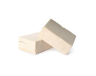 Blocks of compressed yeast on white background