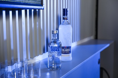 Photo of MYKOLAIV, UKRAINE - SEPTEMBER 23, 2019: Bottles of Finlandia and Absolut vodka on bar counter
