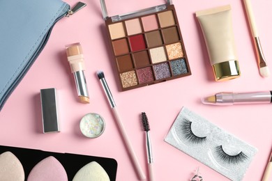 Photo of Set of makeup products on light pink background, flat lay