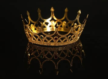 Photo of Beautiful golden crown on black background. Fantasy item