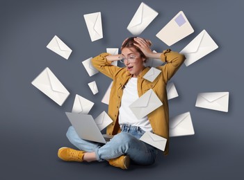 Email spam. Emotional young woman with laptop and many letters on grey background
