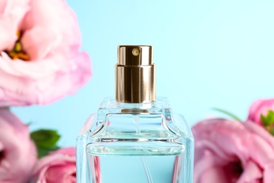 Bottle of perfume on blurred background, closeup