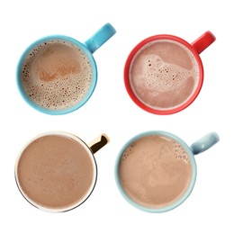 Set of mugs with delicious hot cocoa drink on white background, top view