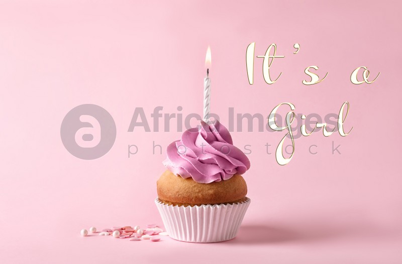 Image of Baby shower cupcake with candle for girl on pink background