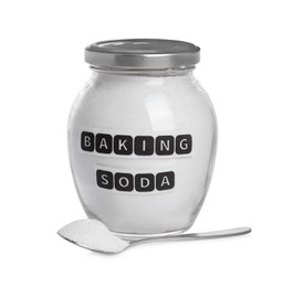 Spoon and jar with baking soda on white background