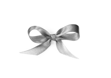 Silver satin ribbon tied in bow on white background, top view