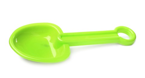 Green plastic toy shovel isolated on white