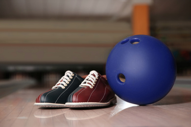 Shoes and ball on bowling lane in club