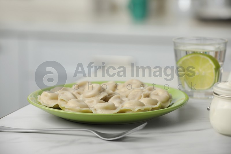 Delicious dumplings on table in kitchen, closeup