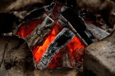 Beautiful bonfire with smoldering firewood, closeup view
