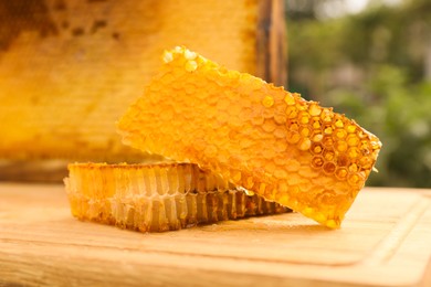 Fresh delicious honeycombs on wooden table outdoors