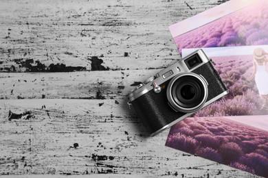 Vintage photo camera and beautiful printed pictures on rustic table, flat lay. Creative hobby