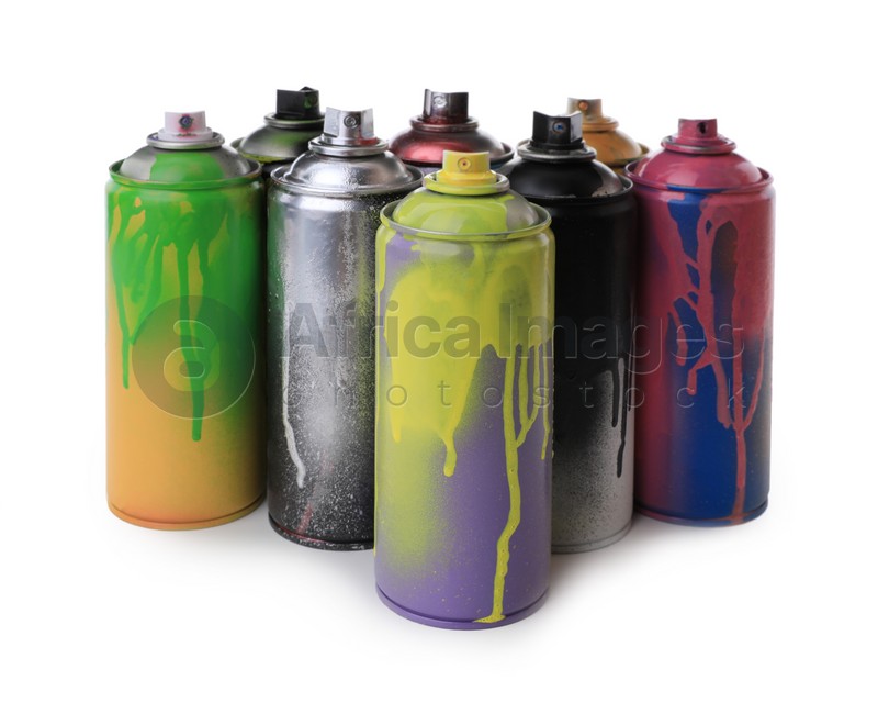 Photo of Used cans of spray paints on white background. Graffiti supplies