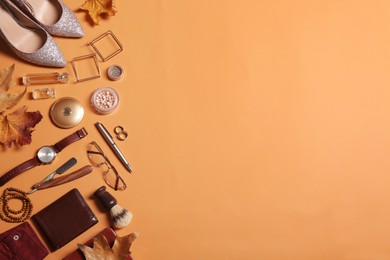 Photo of Flat lay composition with fashionable woman's and man's accessories on orange background. Space for text