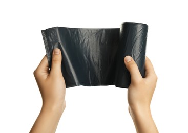 Woman holding roll of black garbage bags on white background, closeup. Cleaning supplies
