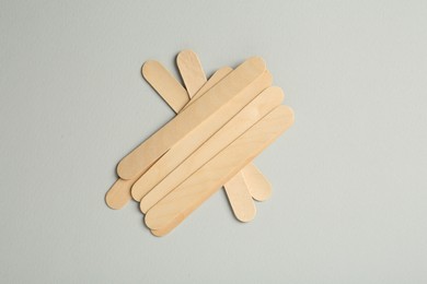 Pile of spatulas on grey background, flat lay