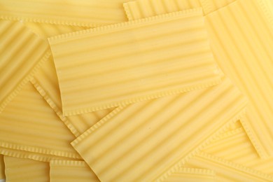 Photo of Pile of uncooked lasagna sheets as background, top view