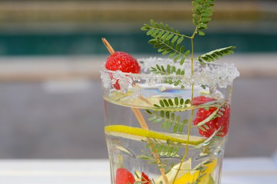 Photo of Delicious refreshing lemonade with raspberries outdoors, closeup. Space for text