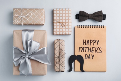 Flat lay composition with bow tie and gift boxes on gray background. Happy Father's Day