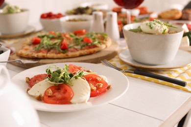 Mozzarella, fresh tomatoes and basil served on buffet table for brunch