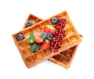 Photo of Delicious Belgian waffles with berries on white background, top view