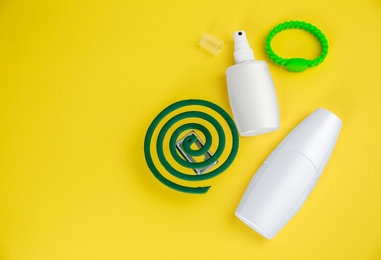 Set of different insect repellents on yellow background flat lay. Space for text
