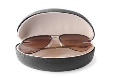 Stylish sunglasses in black leather case on white background