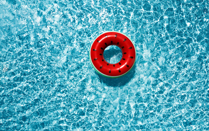 Inflatable ring floating in swimming pool, top view. Summer vacation