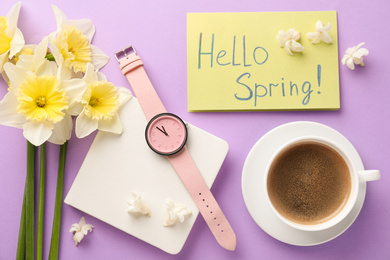 Flat lay composition with words HELLO SPRING, coffee, wristwatch and fresh flowers on violet background