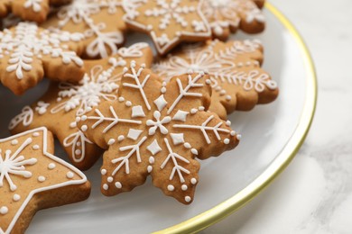 Tasty Christmas cookies on white marble table, closeup