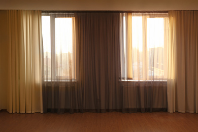 Windows with beautiful curtains in empty room
