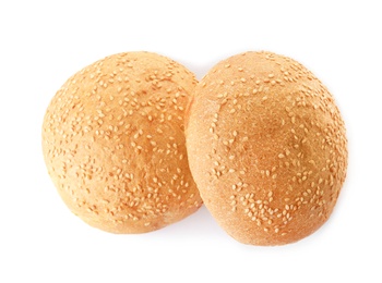 Fresh burger buns with sesame seeds isolated on white, top view
