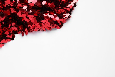 Photo of Beautiful red sequin fabric on white background. Space for text