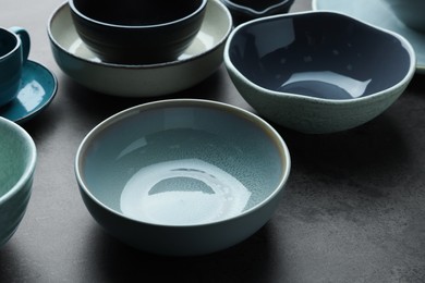 Set of stylish empty bowls on grey table
