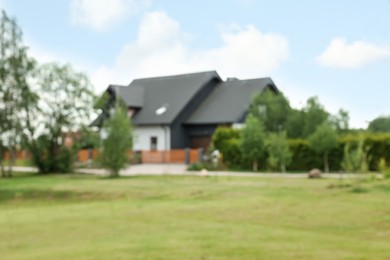 Photo of Blurred view of suburban area with beautiful house