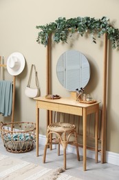 Stylish room decorated with beautiful eucalyptus garland on dressing table