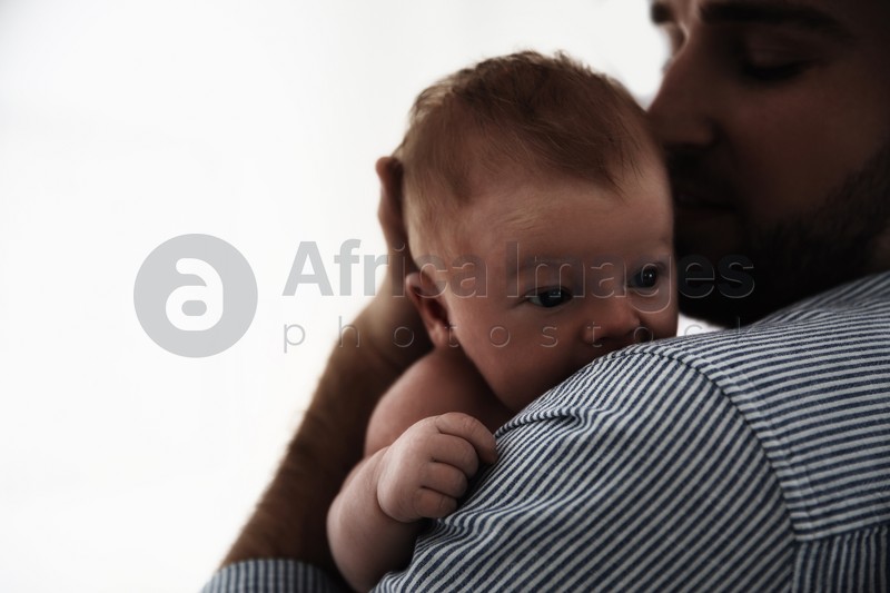 Father with his newborn baby on white background, closeup