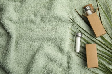 Flat lay composition with natural dental floss on towel. Space for text