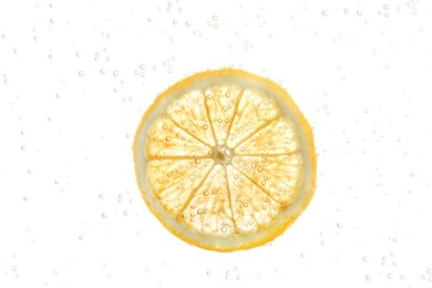 Slice of lemon in sparkling water on white background. Citrus soda