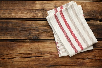 Striped kitchen towels on wooden table, top view. Space for text