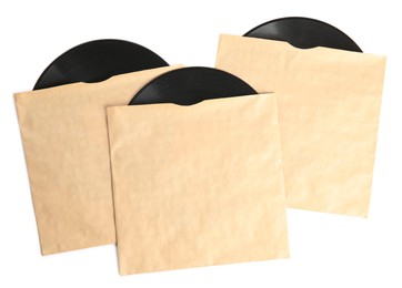 Vintage vinyl records in paper covers on white background, top view
