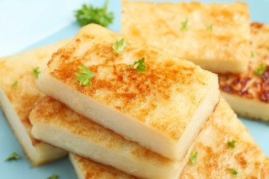 Delicious turnip cake with parsley on plate, closeup