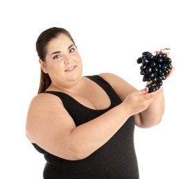 Overweight woman with grapes on white background